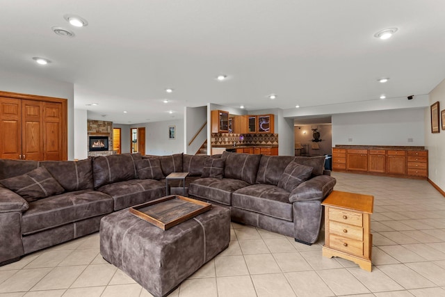 living room with stairway, light tile patterned floors, indoor bar, and recessed lighting