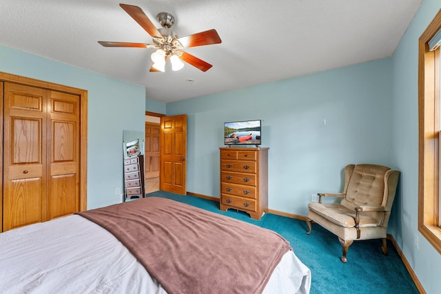 bedroom with a closet, carpet flooring, baseboards, and a ceiling fan