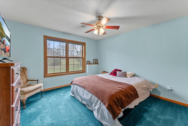 carpeted bedroom with a textured ceiling, baseboards, and ceiling fan