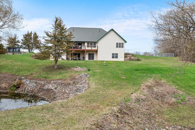 back of house featuring a yard and a deck