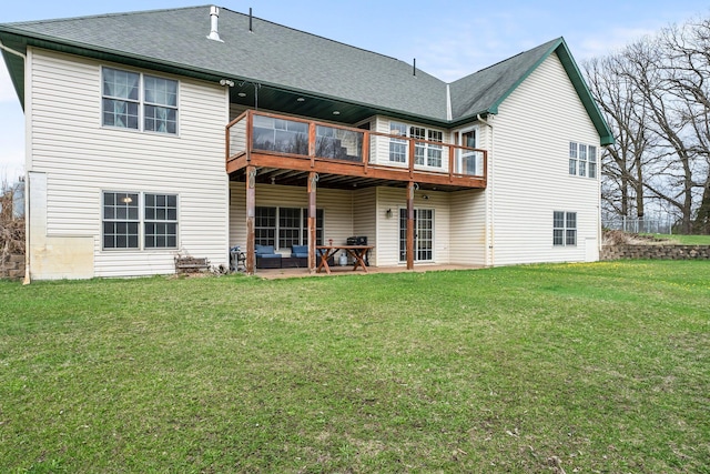 rear view of house with a lawn, a shingled roof, a patio area, and a balcony