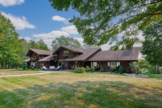 log home with a patio, a front yard, and log exterior