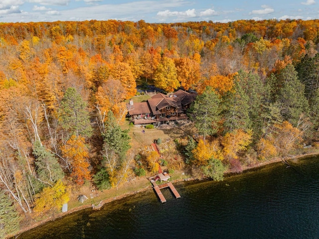 drone / aerial view featuring a water view and a forest view