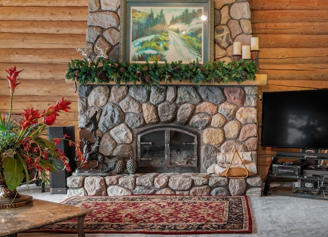 interior details featuring a stone fireplace and rustic walls