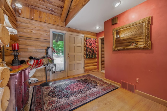 foyer entrance with recessed lighting, baseboards, wood finished floors, rustic walls, and visible vents