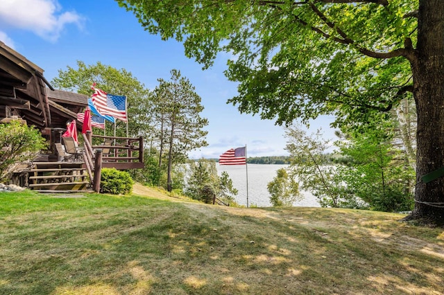 view of yard with a deck with water view
