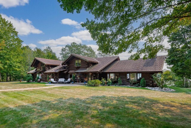 30047 Sunny Beach Rd, Grand Rapids, MN 55744 - log home featuring log siding, a front lawn, and a patio area