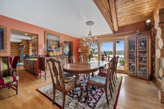 30047 Sunny Beach Rd, Grand Rapids, MN 55744 - dining room featuring rustic walls, light wood-style floors, a chandelier, and a baseboard heating unit