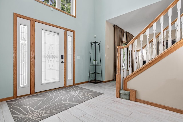 14217 Footbridge Way, Apple Valley, MN 55124 - foyer featuring stairway, wood finished floors, and a towering ceiling