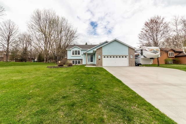 view of front of home featuring an attached garage, driveway, brick siding, and a front yard