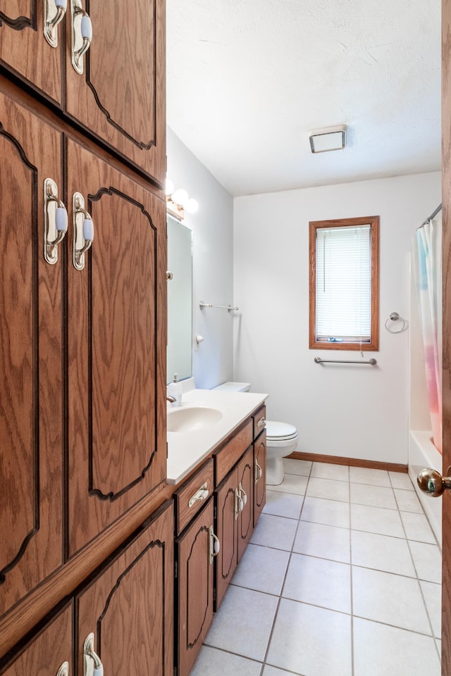 full bath with tile patterned floors, baseboards, vanity, toilet, and shower / bath combo with shower curtain