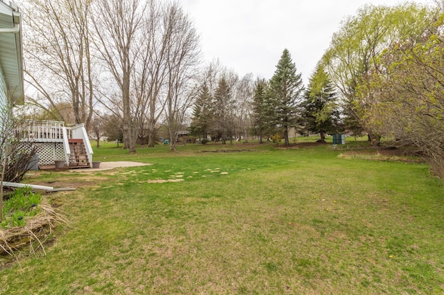 view of yard featuring stairs and a deck