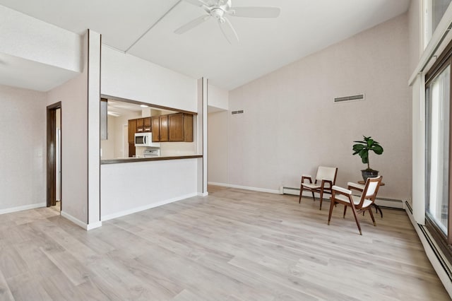 9600 Portland Ave S Unit 322, Bloomington, MN 55420 - sitting room featuring ceiling fan, light wood finished floors, lofted ceiling, baseboards, and a baseboard heating unit