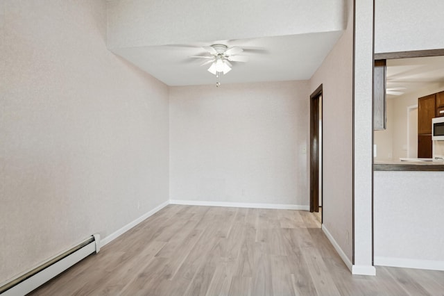 9600 Portland Ave S Unit 322, Bloomington, MN 55420 - spare room with baseboard heating, a ceiling fan, light wood-type flooring, and baseboards