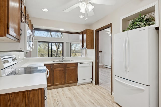 9600 Portland Ave S Unit 322, Bloomington, MN 55420 - kitchen featuring white appliances, a sink, brown cabinetry, ceiling fan, and light wood-style flooring