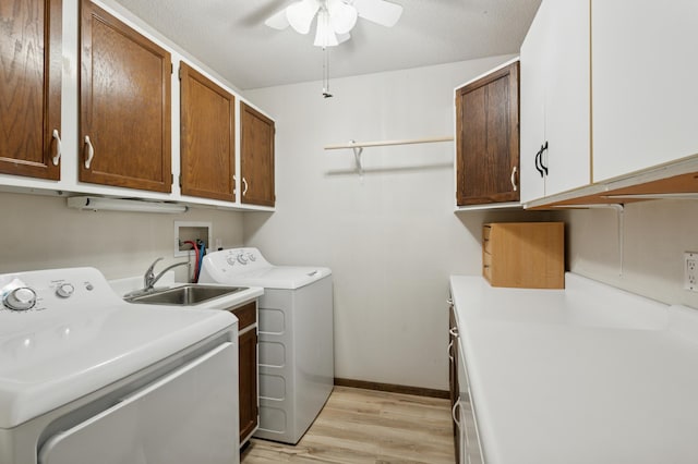 9600 Portland Ave S Unit 322, Bloomington, MN 55420 - washroom featuring cabinet space, washer and dryer, light wood-type flooring, ceiling fan, and baseboards