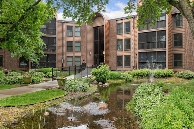 9600 Portland Ave S Unit 322, Bloomington, MN 55420 - view of building exterior with a small pond