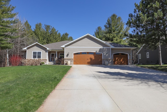 ranch-style house featuring concrete driveway, an attached garage, a front yard, and stone siding