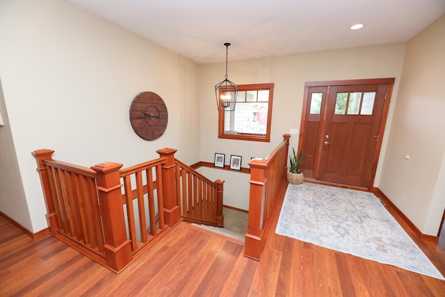 foyer featuring baseboards, recessed lighting, and wood finished floors