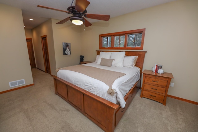 bedroom with baseboards, light carpet, recessed lighting, and visible vents