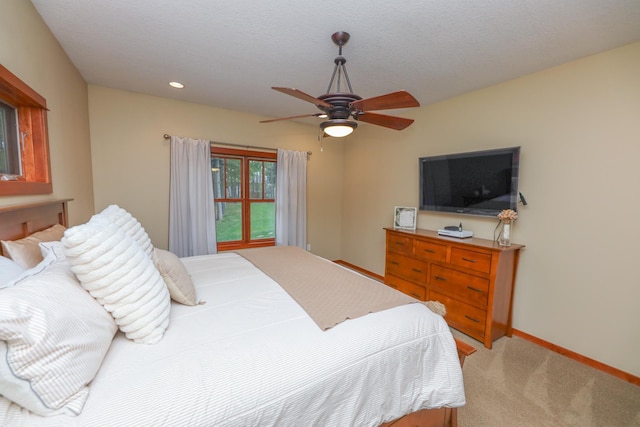 bedroom with light colored carpet, recessed lighting, baseboards, and a ceiling fan