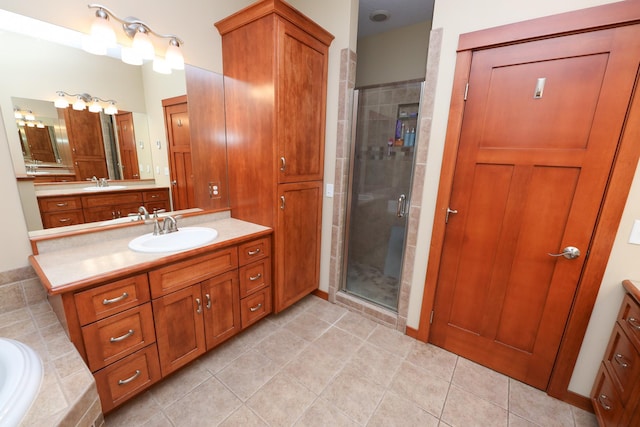 full bath featuring vanity, tiled bath, tile patterned floors, and a stall shower