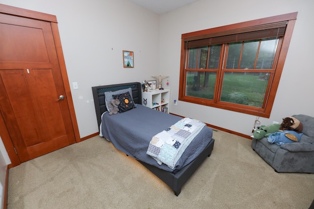 carpeted bedroom with baseboards