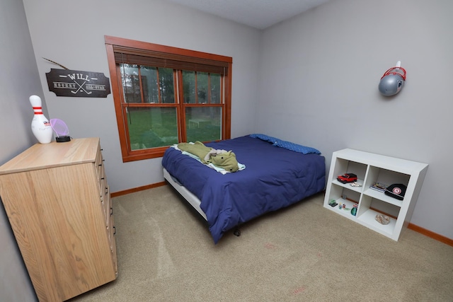 bedroom featuring baseboards and carpet flooring