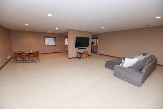 living room with recessed lighting, baseboards, and light colored carpet