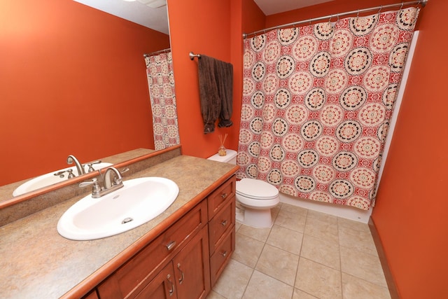 bathroom featuring vanity, tile patterned floors, and toilet