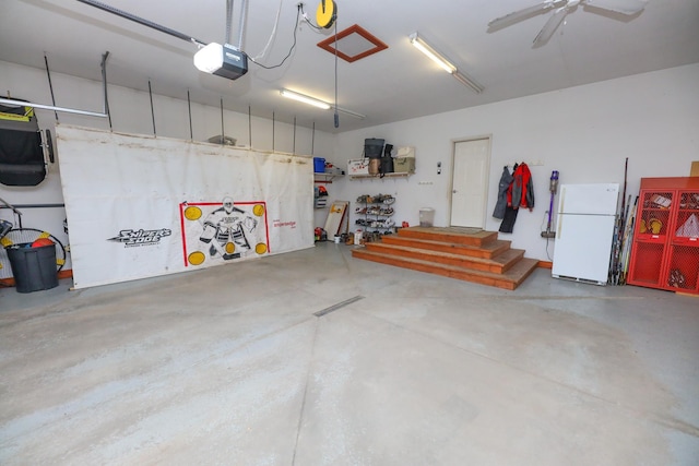 garage featuring a garage door opener and freestanding refrigerator