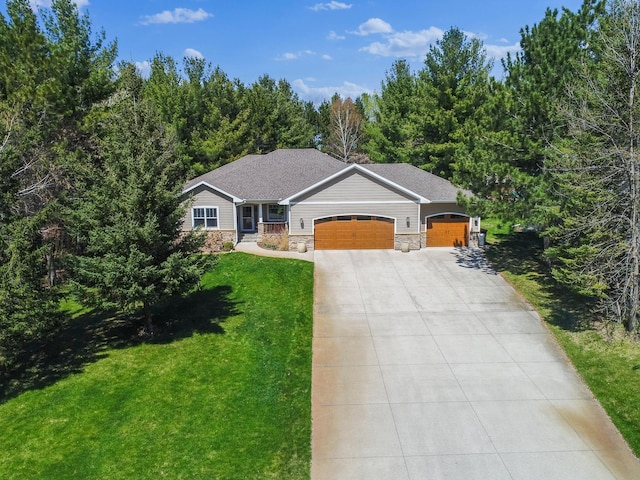 single story home featuring a front lawn, stone siding, a garage, and concrete driveway