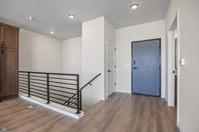 foyer entrance with baseboards, recessed lighting, and wood finished floors