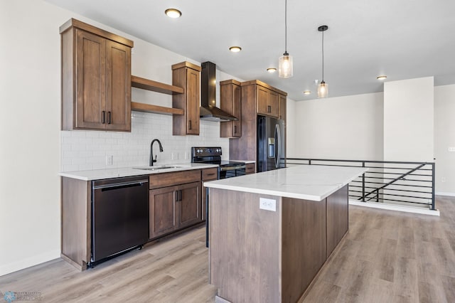 kitchen with open shelves, a sink, wall chimney exhaust hood, stainless steel appliances, and light wood-type flooring