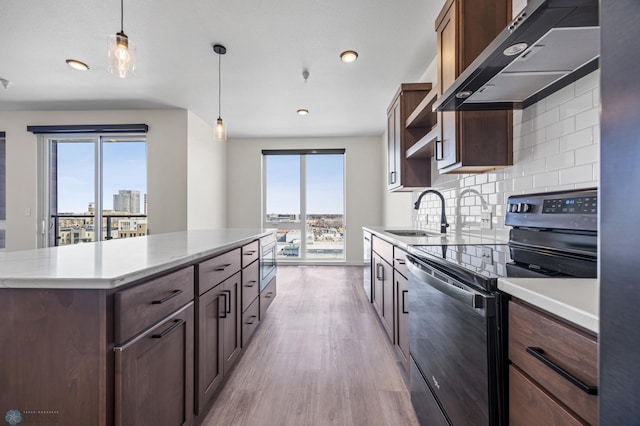 kitchen featuring open shelves, a sink, light wood finished floors, extractor fan, and black electric range oven