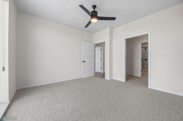 unfurnished bedroom featuring baseboards, a walk in closet, carpet, and a closet