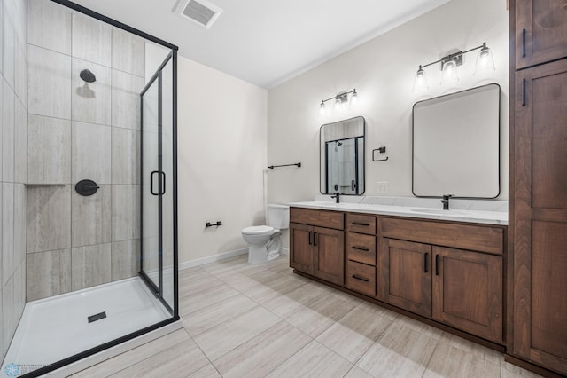 bathroom with visible vents, double vanity, toilet, baseboards, and a shower stall