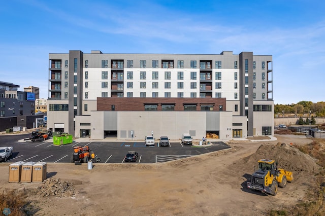 view of building exterior featuring uncovered parking