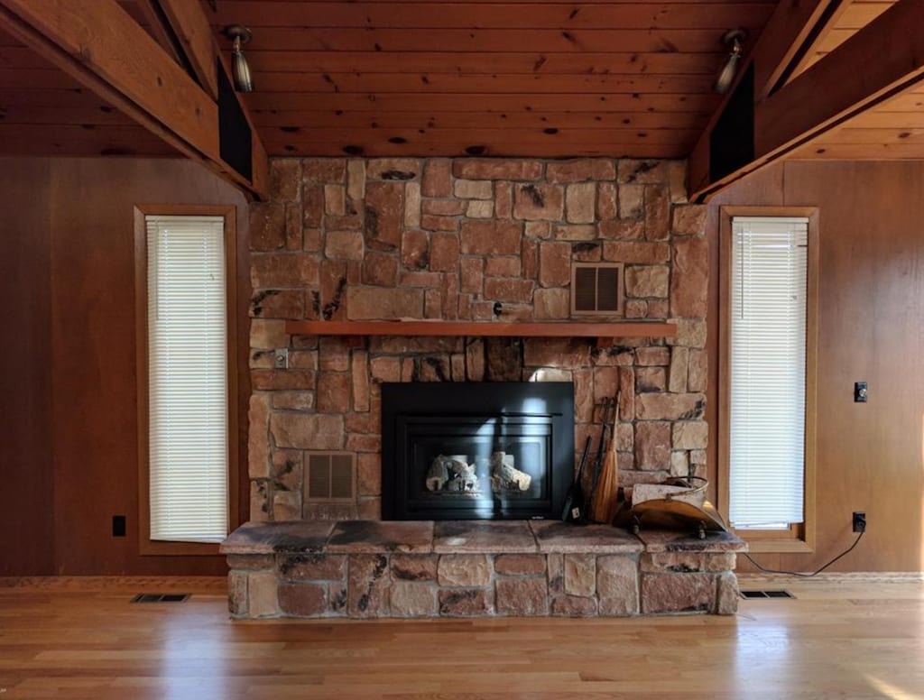 600 Russell St NW, Willmar, MN 56201 - detailed view of wood finished floors, a wood ceiling with exposed beams, a fireplace, and wood walls