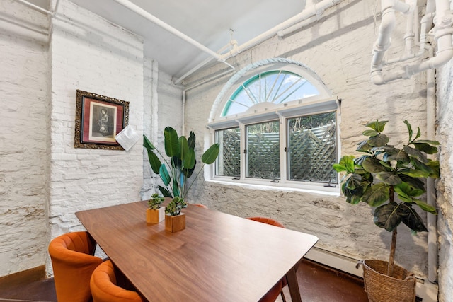 dining room with finished concrete flooring and a baseboard heating unit