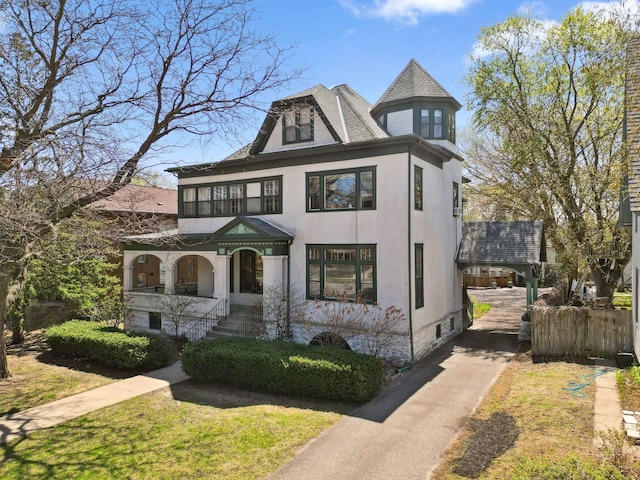 710 Summit Ave Unit 4, Saint Paul, MN 55105 - victorian house featuring stucco siding, driveway, and covered porch