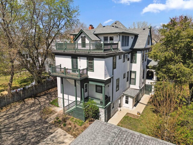 710 Summit Ave Unit 4, Saint Paul, MN 55105 - view of front facade featuring a balcony, stucco siding, a chimney, and fence