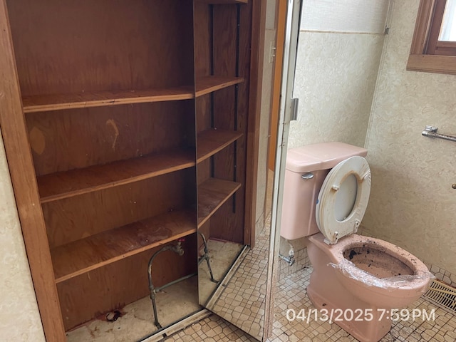 bathroom with toilet and tile patterned floors