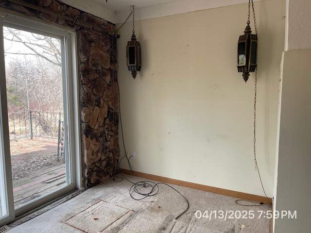 unfurnished room with baseboards