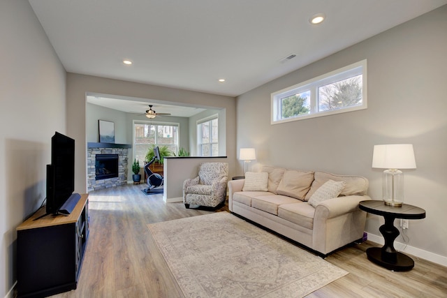 living area featuring a ceiling fan, visible vents, baseboards, recessed lighting, and light wood-style flooring