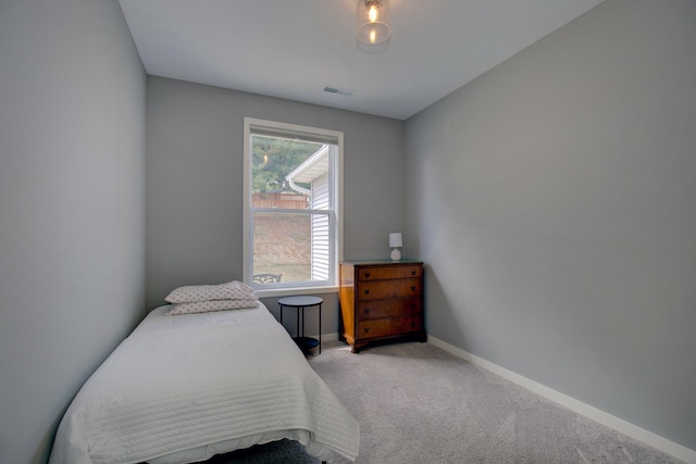 carpeted bedroom with baseboards and visible vents