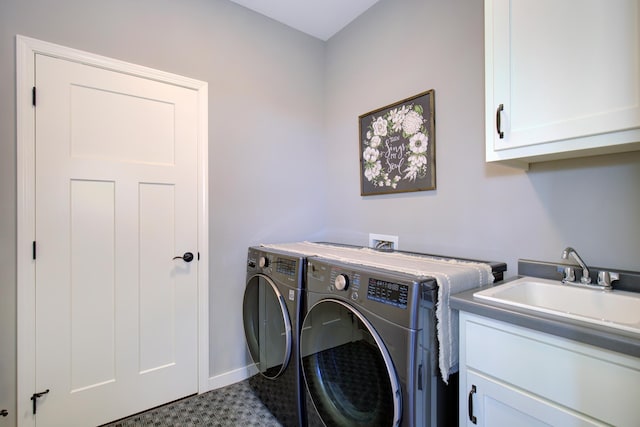 laundry room featuring a sink, separate washer and dryer, baseboards, and cabinet space