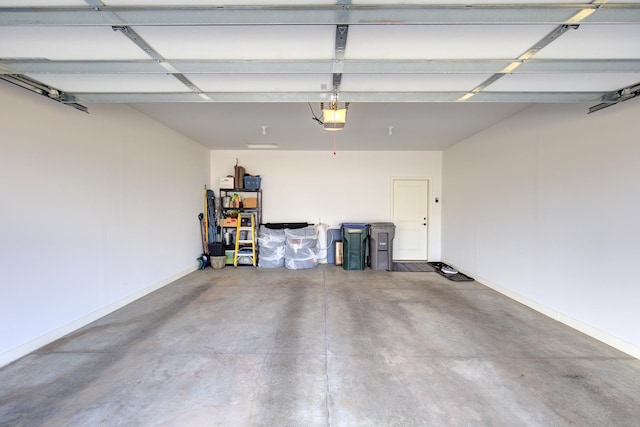 garage with baseboards and a garage door opener