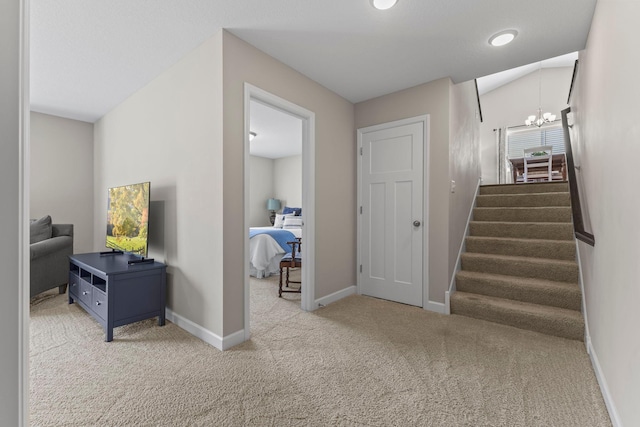 stairs featuring an inviting chandelier, carpet floors, and baseboards