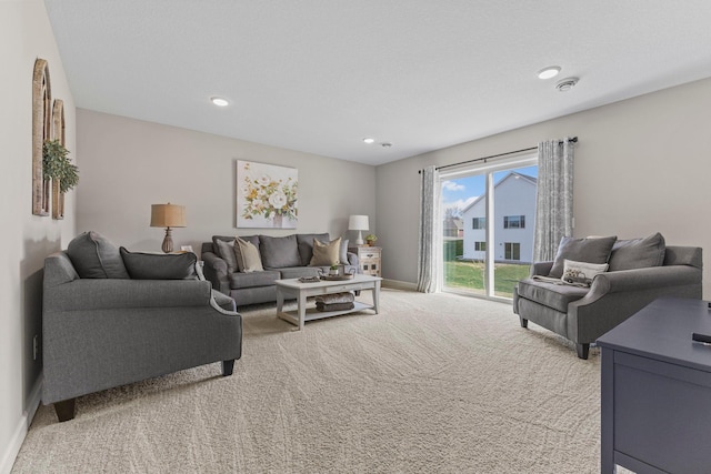 living room featuring baseboards, light carpet, and recessed lighting